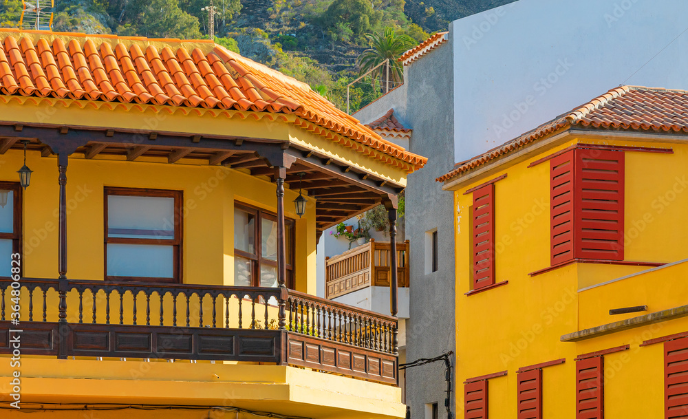 Colorful buildings on a narrow street in spanish town Garachico on a sunny day, Tenerife, Canary islands, Spain.