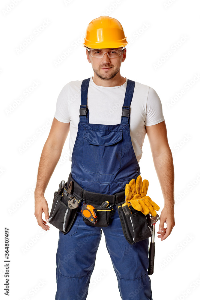 Young caucasian repairman worker in yellow hard hat and uniform. handyman wearing tool belt isolated on white studio background Young caucasian repairman worker in yellow hard hat and uniform. handyman wearing tool belt isolated on white studio background