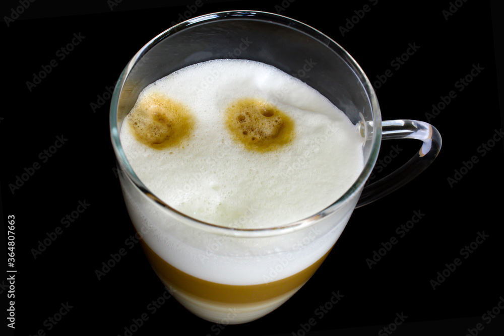 Cup of coffe with milk on a dark background. Hot latte or Cappuccino prepared with milk. Cup of coffe with milk on a dark background. Hot latte or Cappuccino prepared with milk.