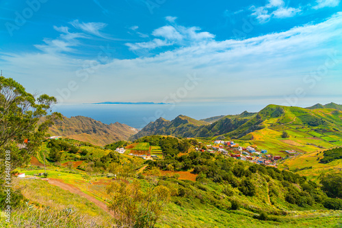 Panoramic landscape of Anaga mountains and ocean. Grand Canaria island on the horizon. Blue sky with clouds on a sunny day, Tenerife Canary Islands, Spain