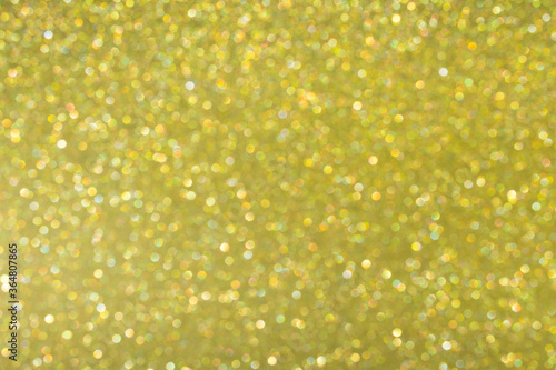 Gold abstract background with bokeh, defocused Christmas lights. Festive concept. Selective focus.