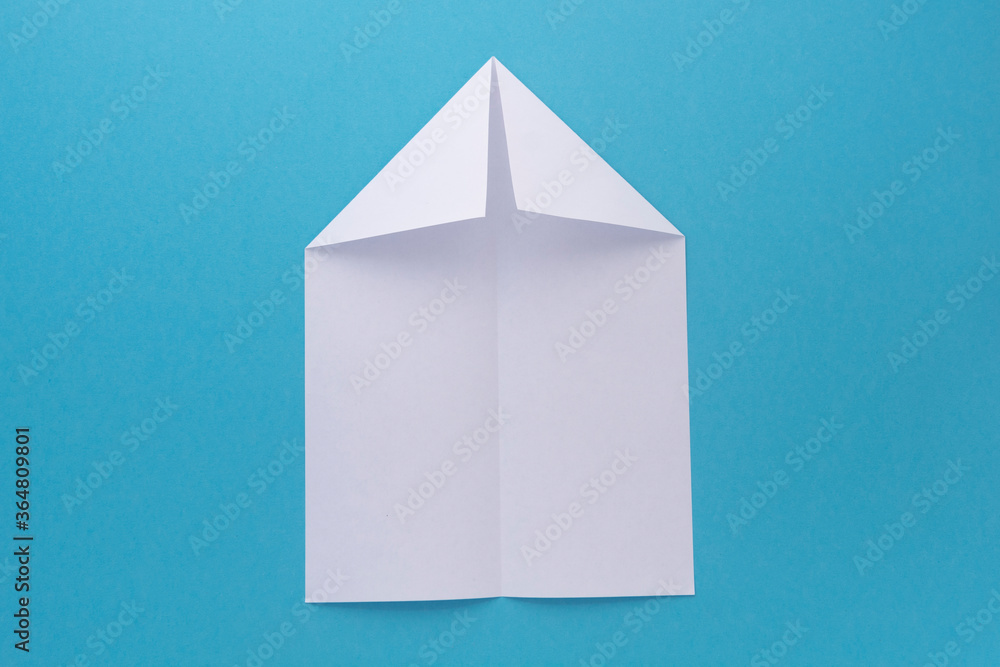 assembly procedure of a paper white airplane. Origami. assembly procedure of a paper white airplane. Origami.