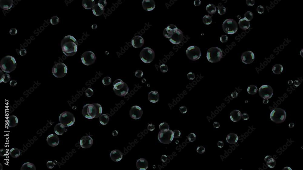 Large soap bubbles slowly rise up on a black background. Large soap bubbles slowly rise up on a black background.