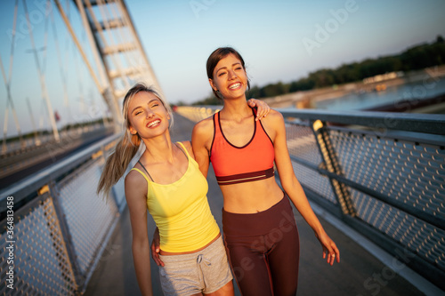 Beautiful happy women friends working out  exercising  running  jogging outdoor.