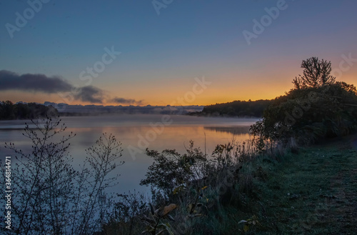Colourful sunrise on Ottawa River with fog on water nobody