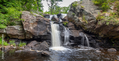 Fototapeta Naklejka Na Ścianę i Meble -  Landscape with waterfall, rocks and leafy green trees at Eightmile River,Chapman Falls, East Haddam, Connecticut Devil's Hopyard State Park