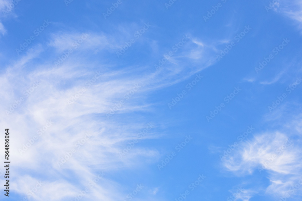 White clouds in the blue sky on a sunny summer day