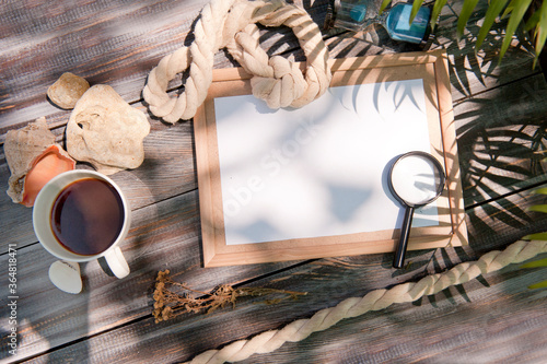 Mock up with empty wooden frame  rope and magnifier  outdoor summer photo