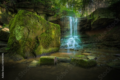 Fotografija Long exposure shot of a small waterfall on the mossy rocks