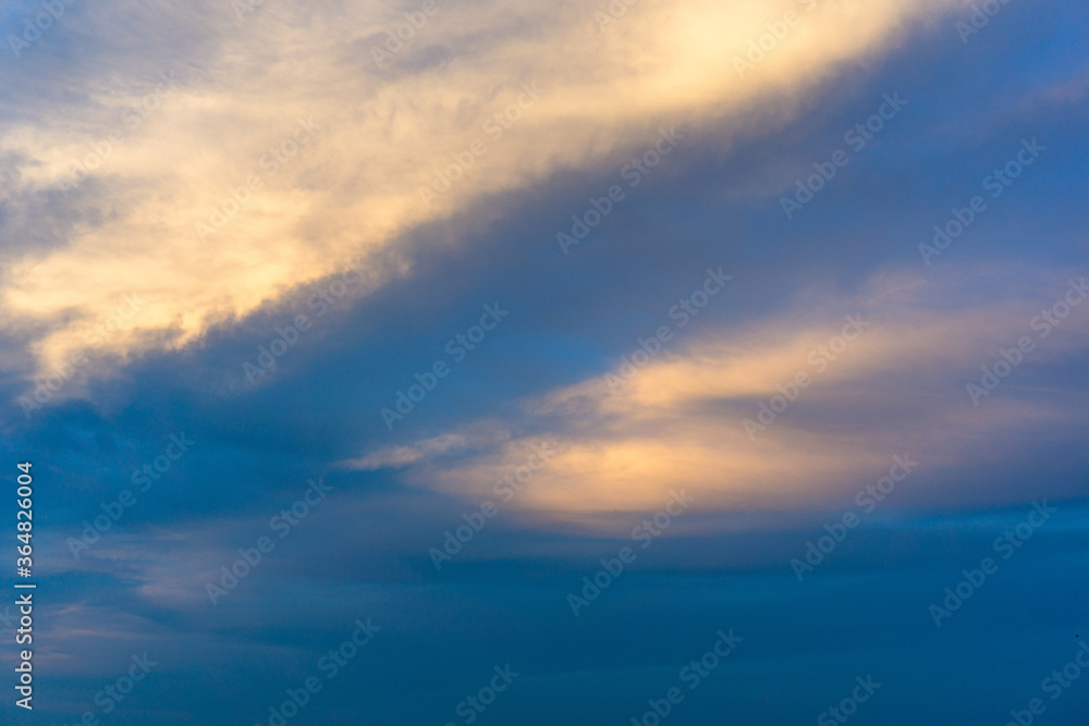 Yellow cloud in navy sunset sky