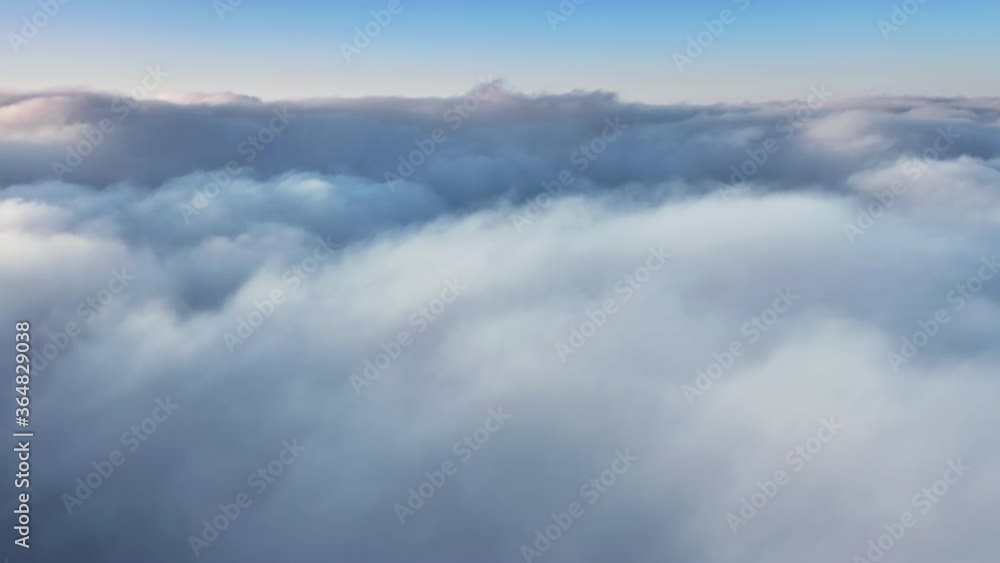 Magical aerial view from drone flying over the scenic skyline with pastel light-blue massive of clouds at sunrise. Nature scenery with blue sky above horizon. 4K of abstract wavy shaped mist skyline Magical aerial view from drone flying over the scenic skyline with pastel light-blue massive of clouds at sunrise. Nature scenery with blue sky above horizon. 4K of abstract wavy shaped mist skyline