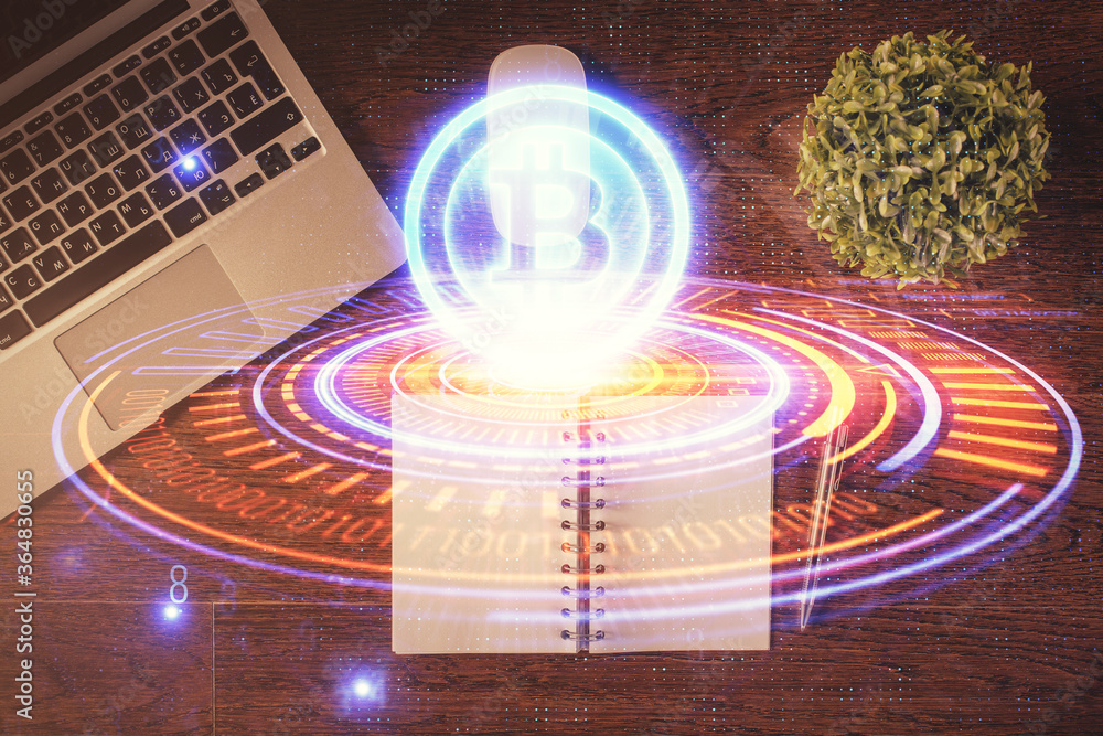 Blockchain theme hologram drawings over computer on the desktop background. Top view. Double exposure. Blockchain theme hologram drawings over computer on the desktop background. Top view. Double exposure.