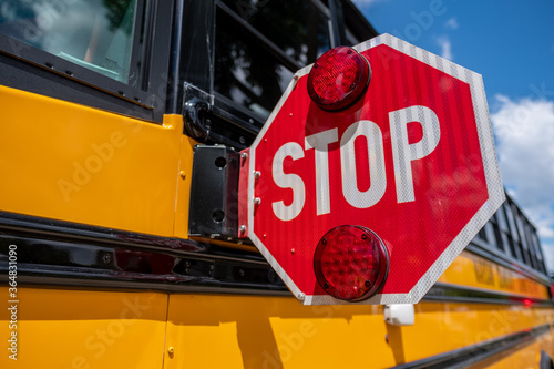 Canvas Print Close up of flashing stop sign on school bus