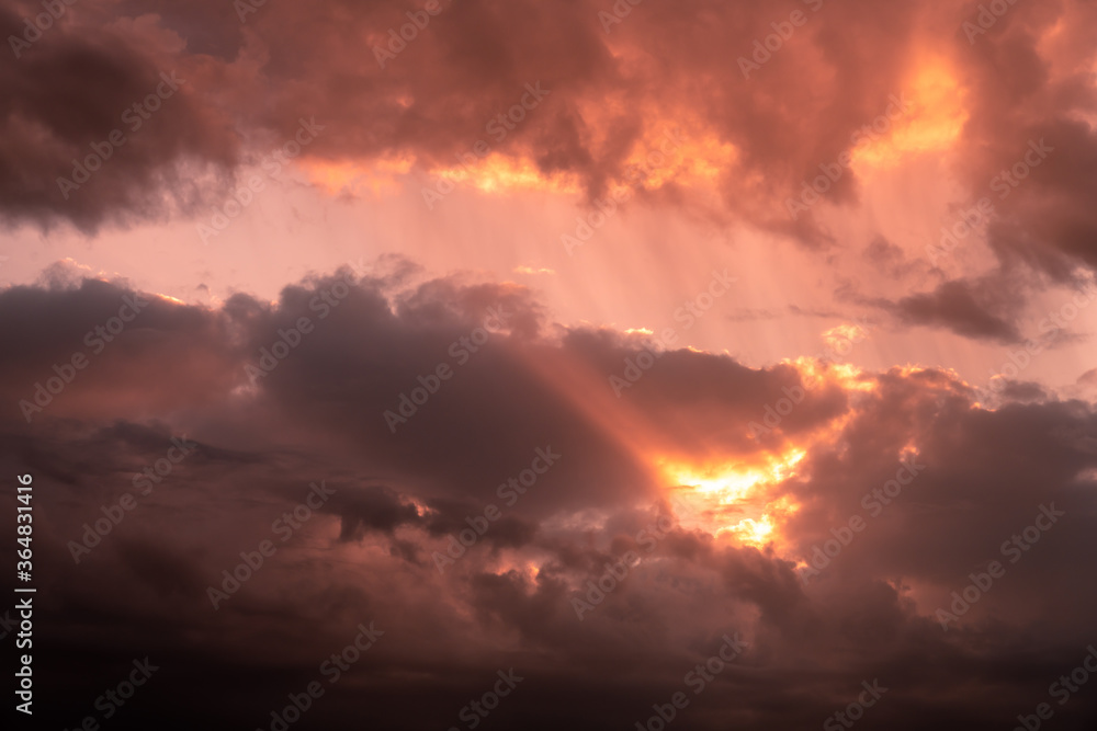 dramatic sunset sky with clouds in orange red color
