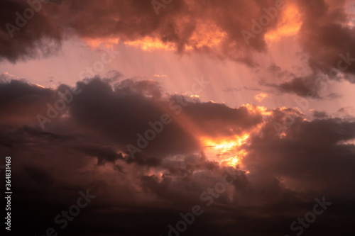 Fototapeta Naklejka Na Ścianę i Meble -  dramatic sunset sky with clouds in orange red color