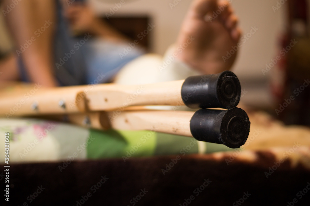 Gypsum is imposed on the man’s leg and walking on crutches is