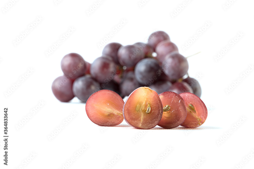 Image of grapes cut with a bunch of grapes out of focus, white background. Image of grapes cut with a bunch of grapes out of focus, white background.