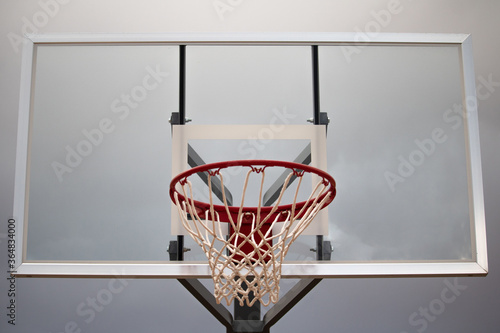 Close up of a netted basketball hoop ready for some b-ball action. © Beano
