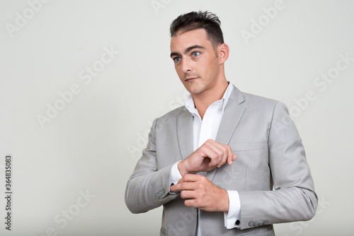 Portrait of young handsome businessman wearing suit