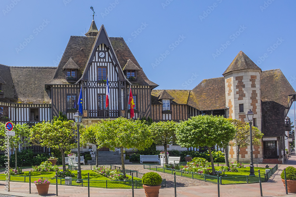 Town Hall (Mairie) in Deauville decorated with flags and flowers. Town