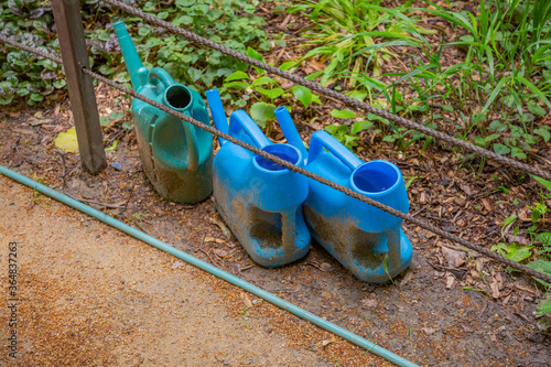 Blue plastic watering can for irrigation and watering of flowers and garden plants