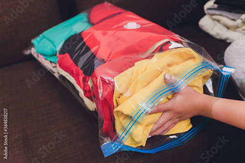 Space saver saving seal bag sucking air out , vacuum clothing storage compressed package. photo