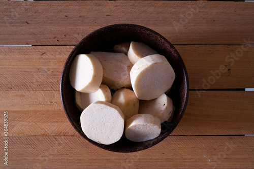 Fresh yam roots in a bowl. Top view