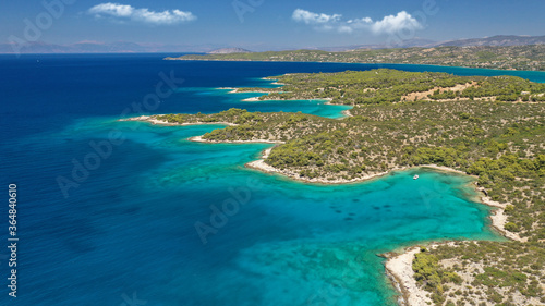 Fototapeta Naklejka Na Ścianę i Meble -  Aerial drone photo of beautiful fjord landscape forming turquoise beaches in small vegetated coves in Porto Heli a popular anchorage for yachts and sail boats, Argolida, Greece