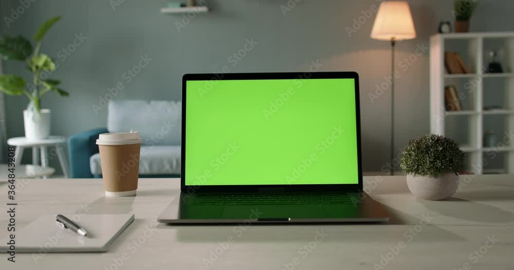 Copy space template - close up shot of modern laptop with chroma key green set up for work in living room at home - technology, design concept 4k zoom shot Copy space template - close up shot of modern laptop with chroma key green set up for work in living room at home - technology, design concept 4k zoom shot