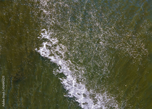 Seashore with rolling waves, view from a height