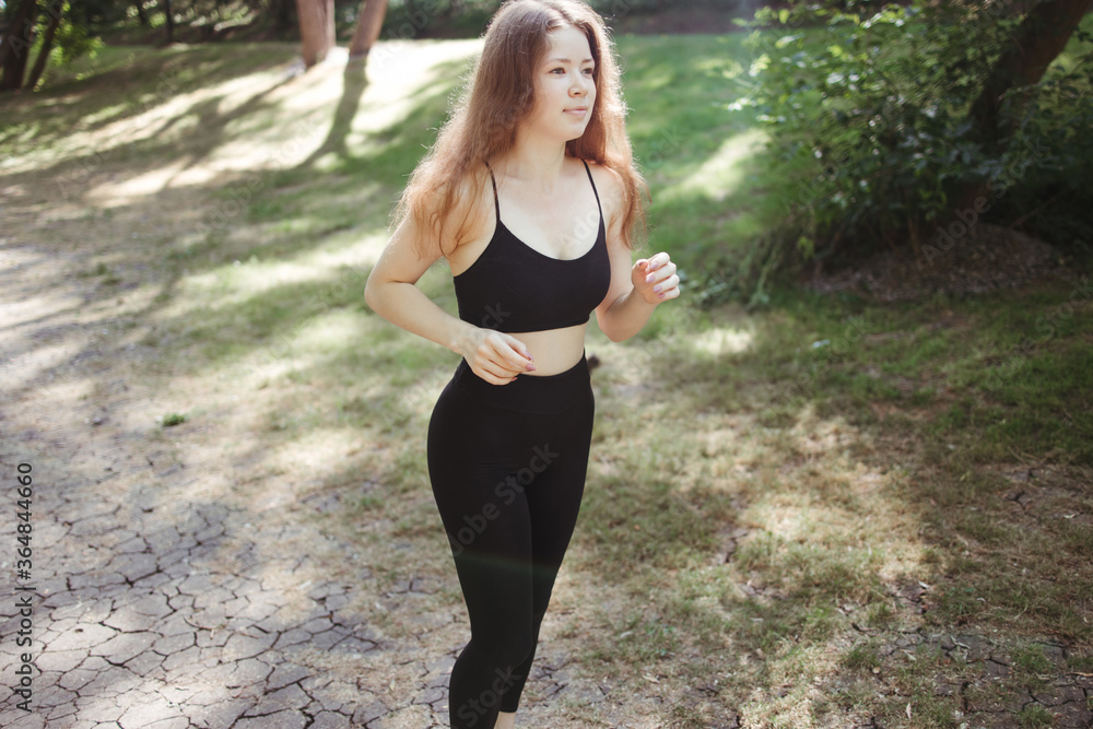 Sport, fitness, healthy lifestyle, cardio training. Active woman with athletic body running in the park. Female jogger working out outdoor Sport, fitness, healthy lifestyle, cardio training. Active woman with athletic body running in the park. Female jogger working out outdoor
