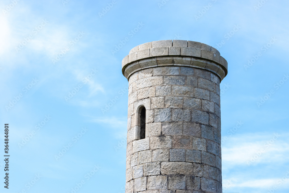 Top of an old castle tower with opened windows