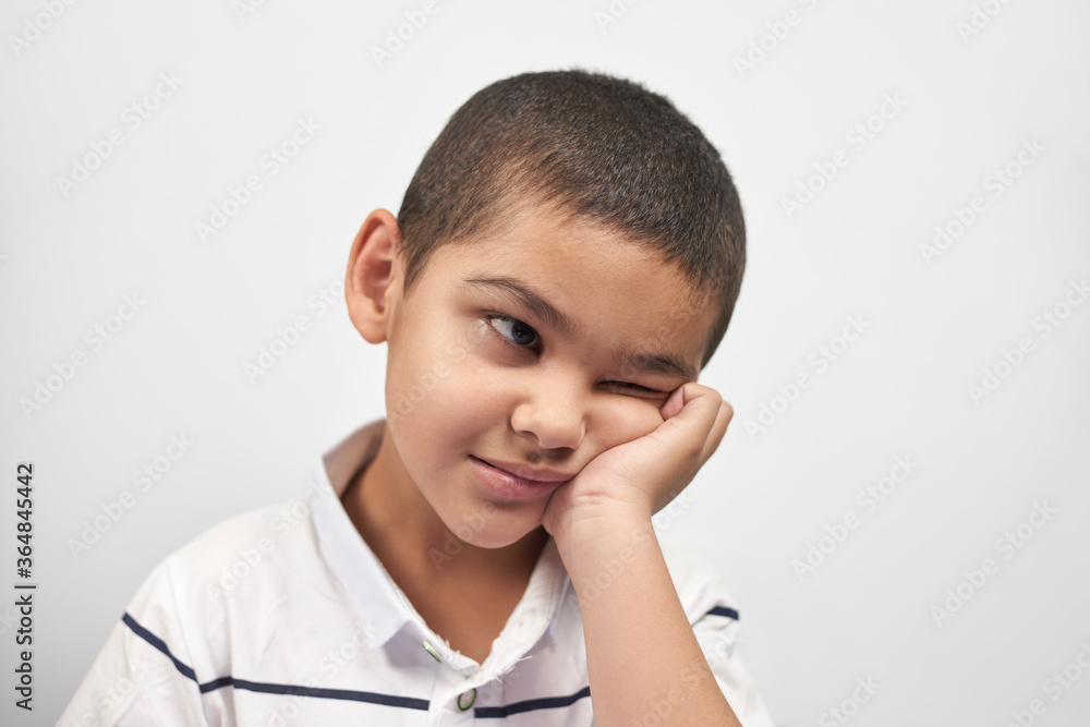 Bored schoolboy looking tired of doing homeworks. Kid trying to concentrate. Doing online classwork with laptop. Online school, homeschooling or distance education due to covid-19 Bored schoolboy looking tired of doing homeworks. Kid trying to concentrate. Doing online classwork with laptop. Online school, homeschooling or distance education due to covid-19