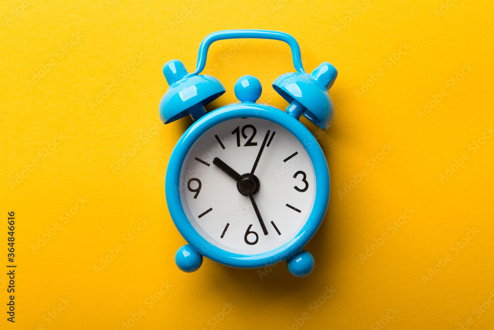 Clock Isolated On Yellow Background Clock Isolated On Yellow Background