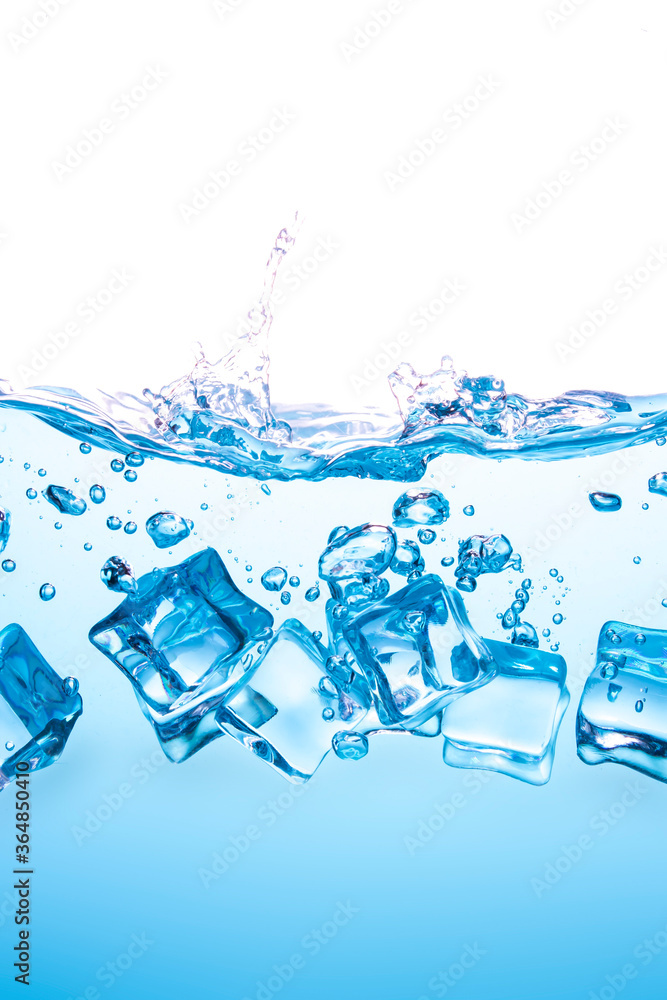 Many ice cubes fall into the blue water, causing the water to spread, creating beautiful bubbles. Many ice cubes fall into the blue water, causing the water to spread, creating beautiful bubbles.