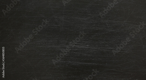 Dark, grunge and scratched chalkboard texture may used as background
