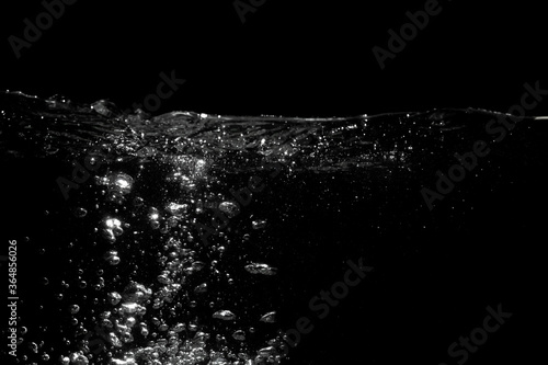Abstract water background. Water splash with air bubbles water on black background.