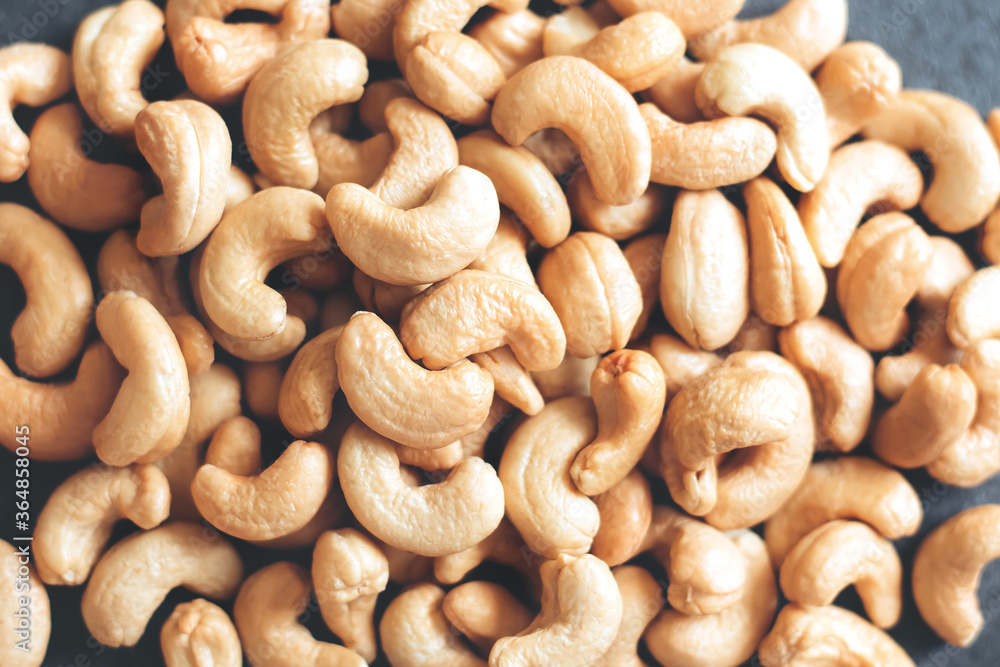 Nuts Cashews are scattered as a background on a table