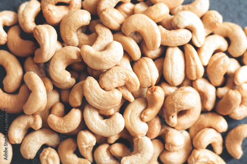 Nuts Cashews are scattered as a background on a table