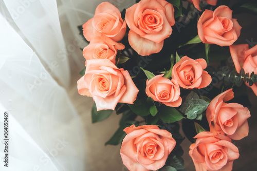 Bouquet of light pink roses on window background. Close up