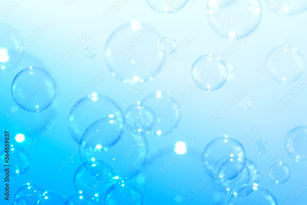 Clear soap bubbles float on a blue background. Bubbles abstract background Clear soap bubbles float on a blue background. Bubbles abstract background
