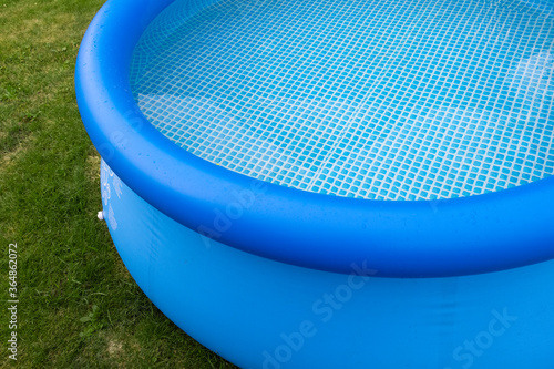 Part of a blue inflatable pool in the backyard of a private house.