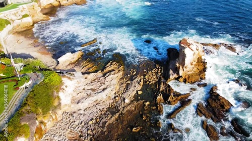 Beach. Newport Coast, California. Gorgeous birds-eye-view over crashing waves and rocks heading westbound, stunning. 19 sec. photo