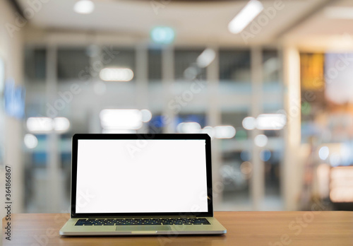 laptop on table  in the office background.