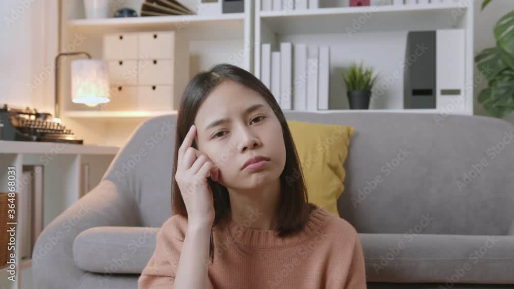 Young Asian woman sitting on sofa and thinking have idea. Young Asian woman sitting on sofa and thinking have idea.