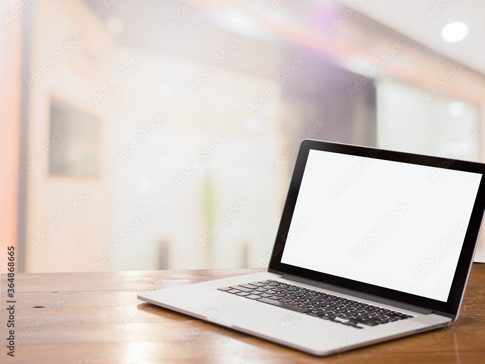laptop with blank screen on table in the mall background. laptop with blank screen on table in the mall background.