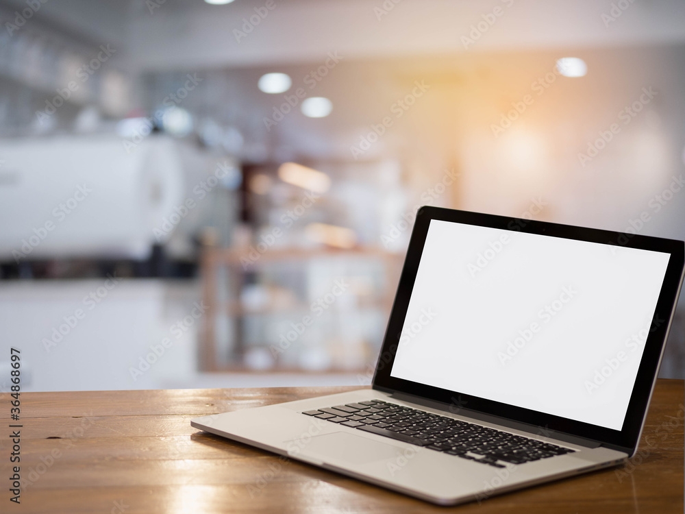 Modern technology and communication concept. Close up view of open notebook computer on table in cafe background.