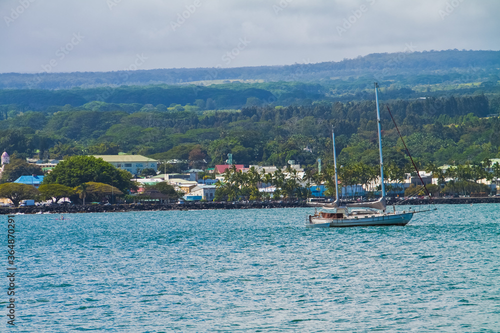 Sailboat and Kayak Paddling in in Hilo Bay With Downtown Hilo From The