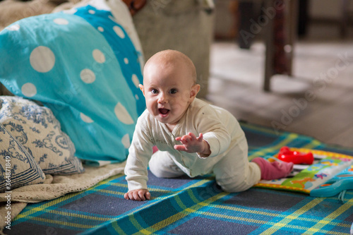 .7 month old baby girl on the bed looking at the camera