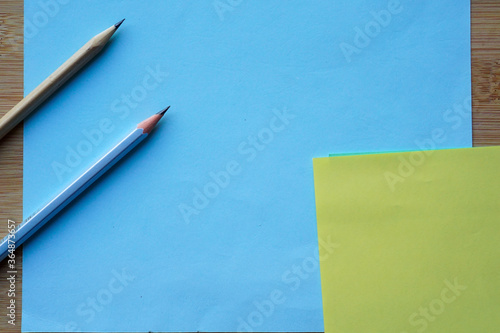 Pastel Color paper and pencil for background. minimalist back to school copy space concept for text.